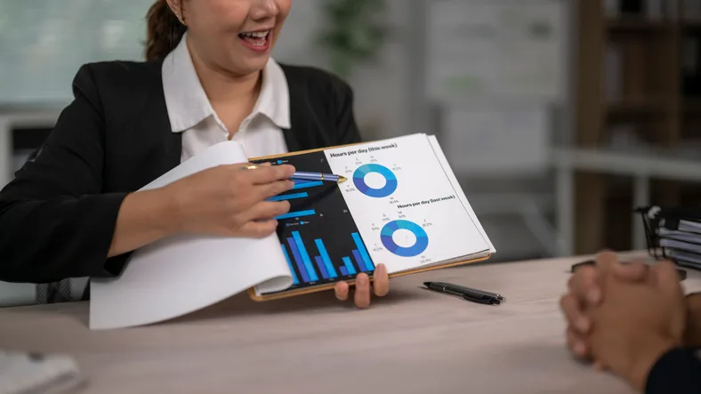 Advisor presenting charts in a report to a client